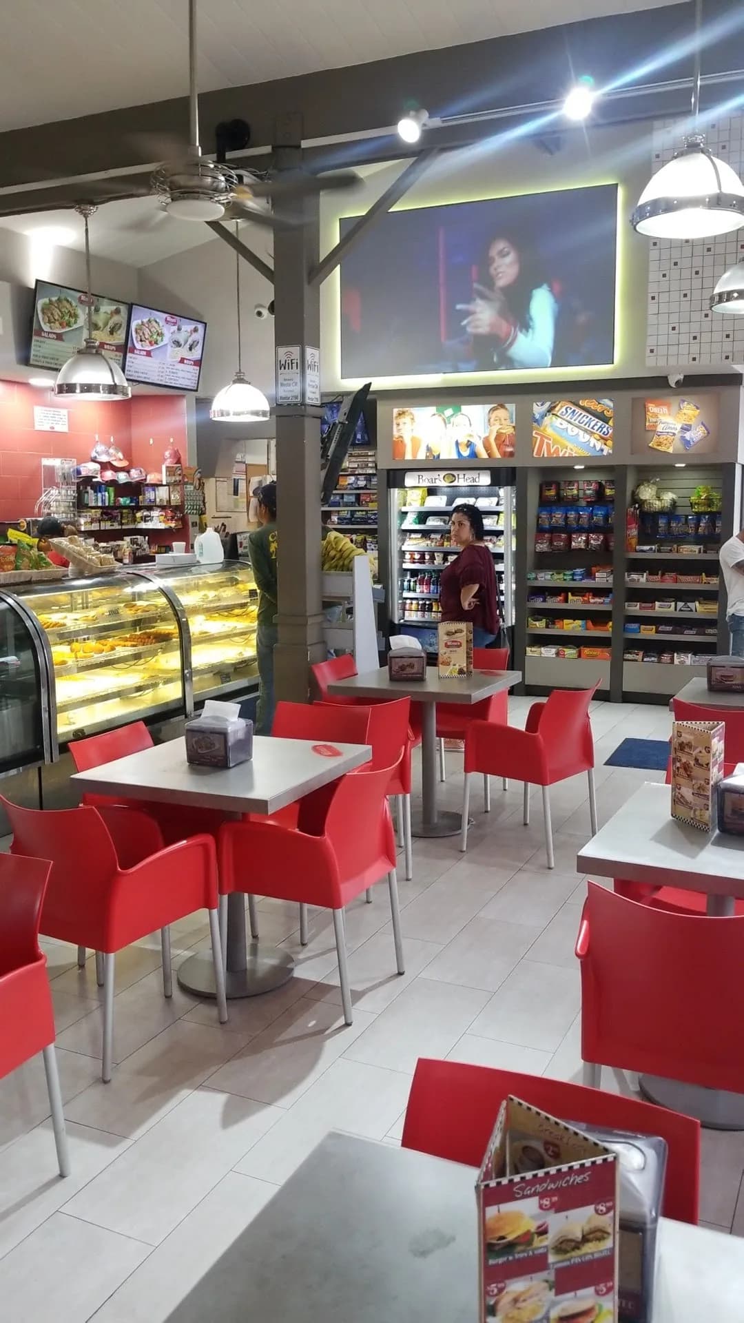 Inside Mima's Kitchen — red chairs and pastry display cases